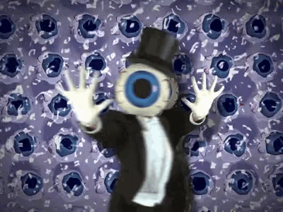 a man in a tuxedo and top hat has a big eye on his face