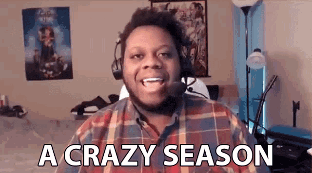 a man wearing headphones and a plaid shirt is talking into a microphone and says `` a crazy season '' .