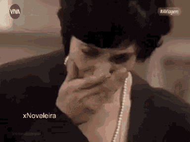 a woman covering her mouth with her hand and a purple circle that says viva on it