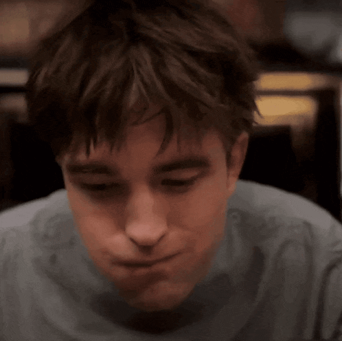 a close up of a man 's face with a serious look on his face