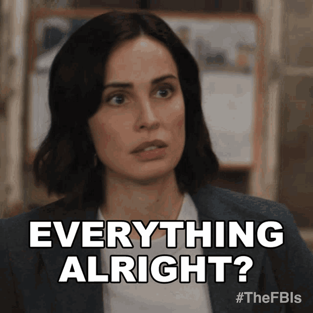 a woman says " everything alright " while wearing a suit and white shirt