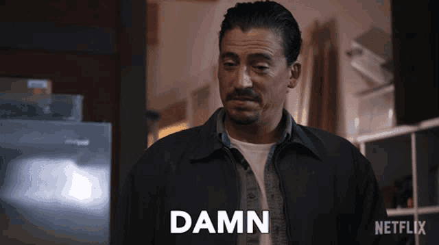 a man in a black jacket says damn in front of a netflix sign