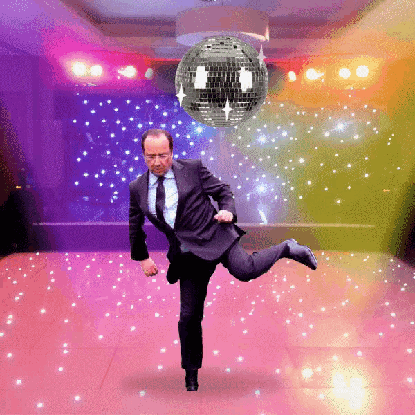 a man in a suit and tie is dancing on a pink dance floor