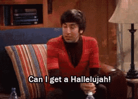 a man in a red shirt is sitting on a couch and saying can i get a hallelujah .
