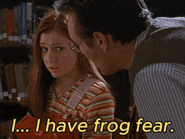 a man and a woman in a library with the words i have frog fear on the bottom