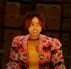 a woman in a floral jacket is smiling in front of a wall of boxes