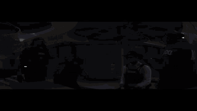 a man in a police uniform is talking to another man in front of a yellow building