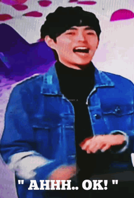 a man in a blue jacket and black turtleneck says ahhh ok