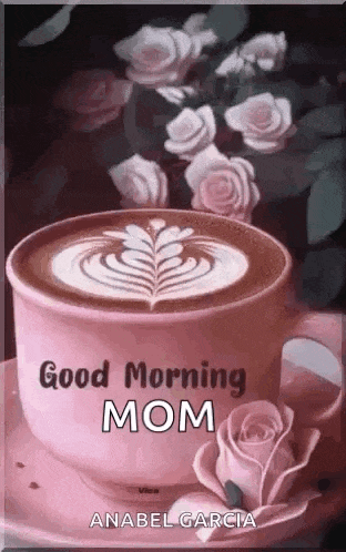 a cup of coffee on a saucer with roses in the background and the words `` good morning mom '' .