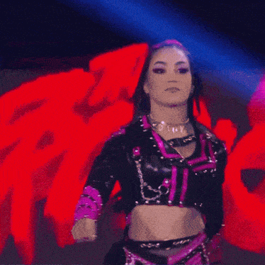 a woman in a purple and black outfit has the number 19 on her collar
