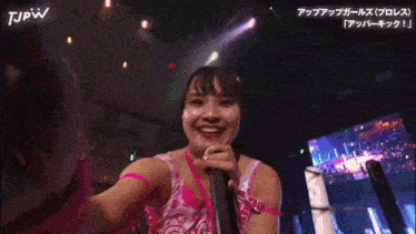 a woman is holding a microphone and smiling in a tjpw advertisement