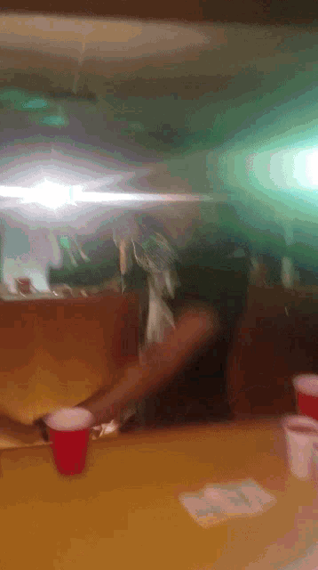 a blurred image of a table with a red cup on it