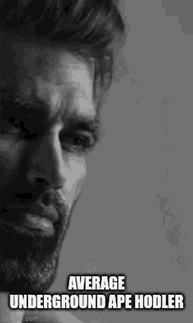 a black and white photo of a man with a beard .