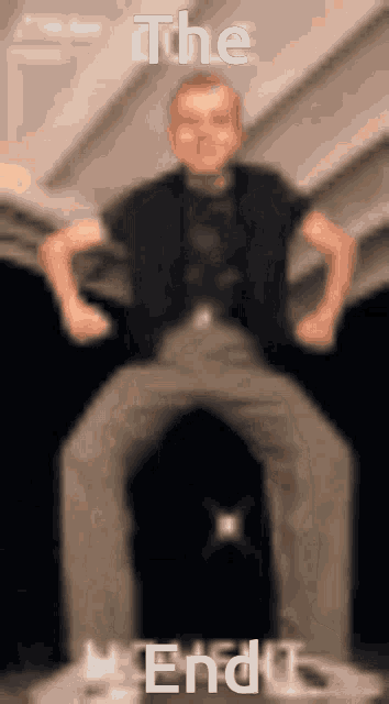 a blurry picture of a man with the words " the end " written above him