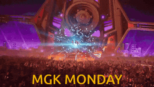 a crowd of people at a concert with mgk monday written in yellow letters