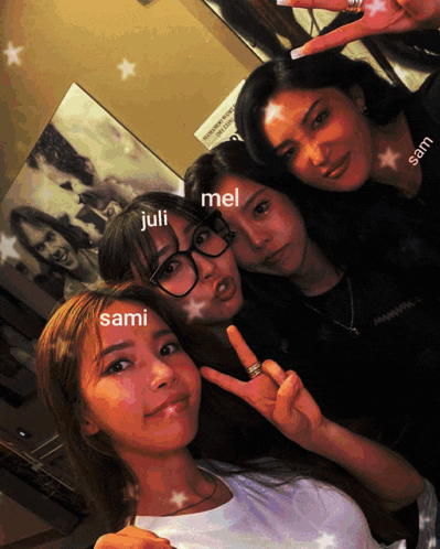 three girls are posing for a picture and one of them has the name juli on her face