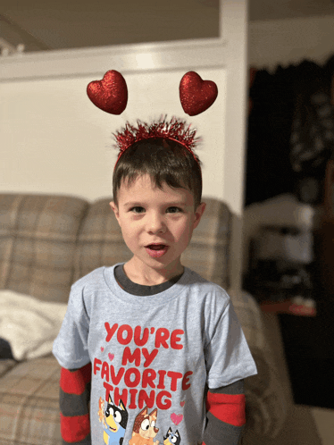 a young boy wearing a headband that says you 're my favorite thing