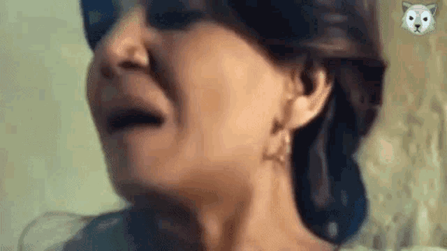 a close up of a woman 's face with her mouth open and a dog on the corner of her face .