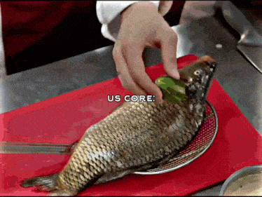 a person is putting a green pepper on top of a fish with the words us core below it