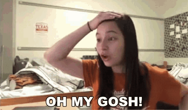 a girl in an orange shirt says oh my gosh while holding her head