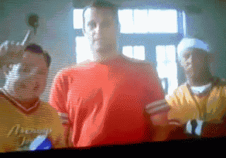 a man in a red shirt is surrounded by other men