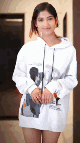a girl wearing a white hoodie with a picture of a man on it