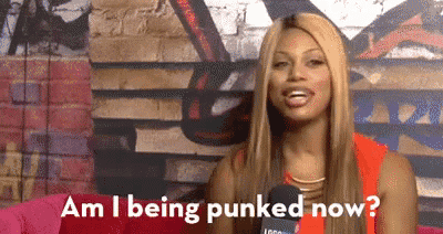 a woman is talking into a microphone and asking am i being punked now