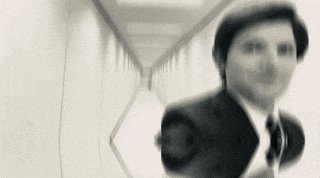 a man in a suit and tie standing in a hallway