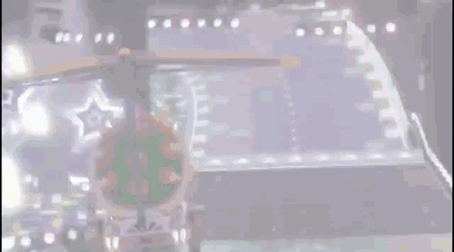 a blurred image of a roller coaster with a star in the background