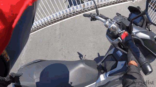 a person riding a motorcycle with the word motorcycle on the bottom left