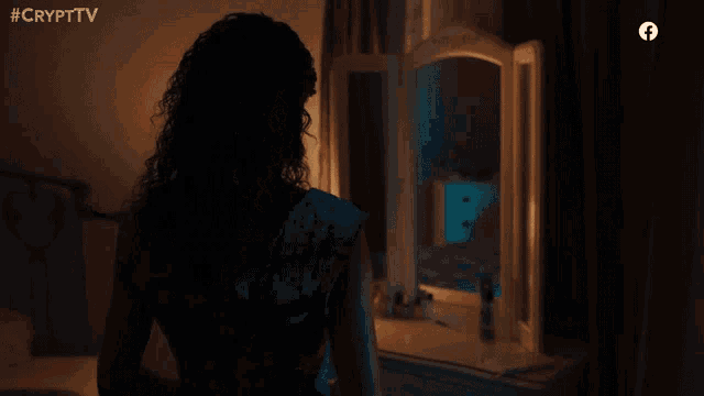 a woman is looking at herself in a mirror with the hashtag #crypttv