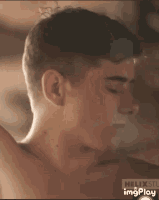 a close up of a man 's face with the word helix visible