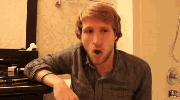 a man making a funny face in a bathroom