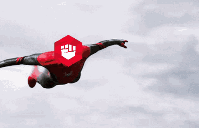 a man in a superhero costume is flying through the air with a shield on his head