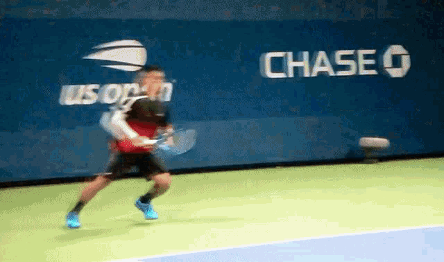 a tennis player is playing in front of a chase sign