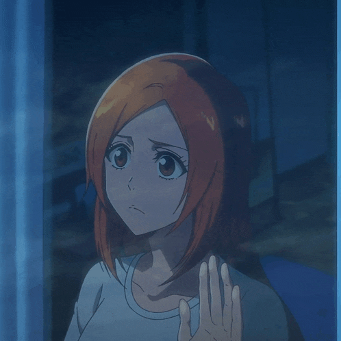 a girl with red hair looks out of a window