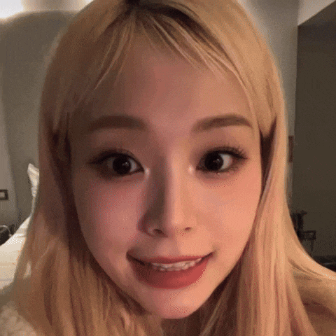 a close up of a woman 's face with blonde hair and a red lip .