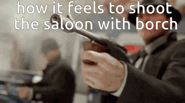 a man in a suit is holding a gun in his right hand and says how it feels to shoot the saloon with borch .