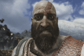 a bald man with a beard and blood on his face looks at the camera