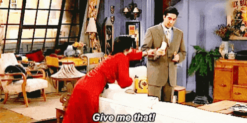 a woman in a red dress is standing next to a man in a suit and says give me that ..