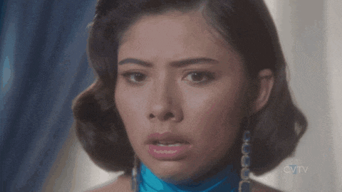 a woman with a blue scarf around her neck looks at the camera with cvtv in the corner