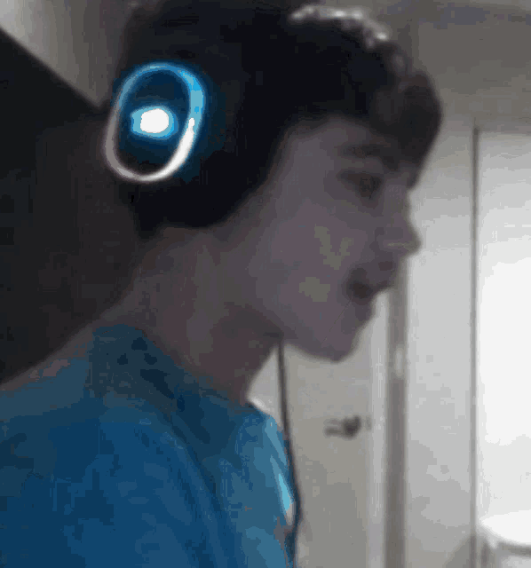 a young man wearing headphones with a glowing circle on them