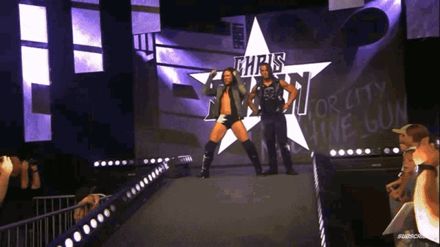 two wrestlers are walking down a ramp with a star in the background that says " chris benoit "
