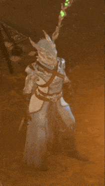a person holding a stick with a green light behind them