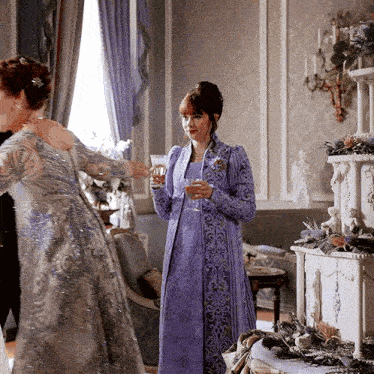 a woman in a purple dress is holding a glass