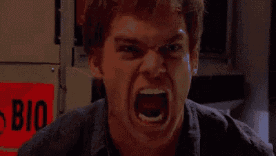a close up of a man 's face with a very angry expression .