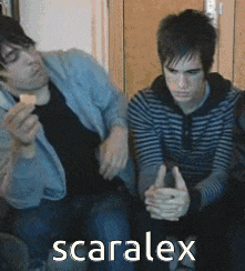 two men are sitting next to each other with the word scaralex on the bottom right