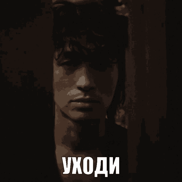 a close up of a man 's face with the word " yxodi " written in white