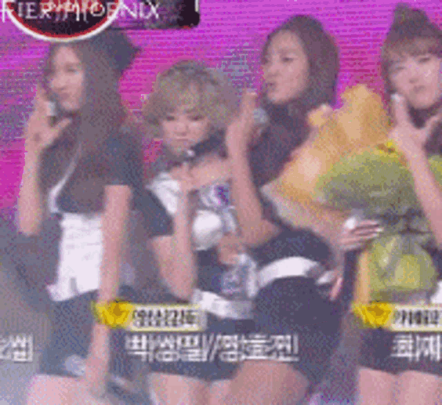 a group of girls are standing in front of a screen that says fieryphoenix