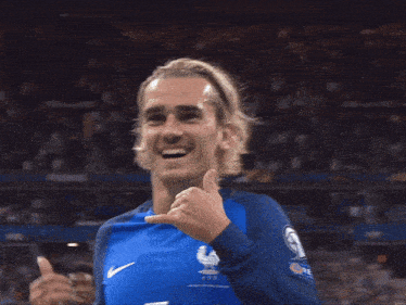 a man in a blue shirt with the number 1 on his chest
